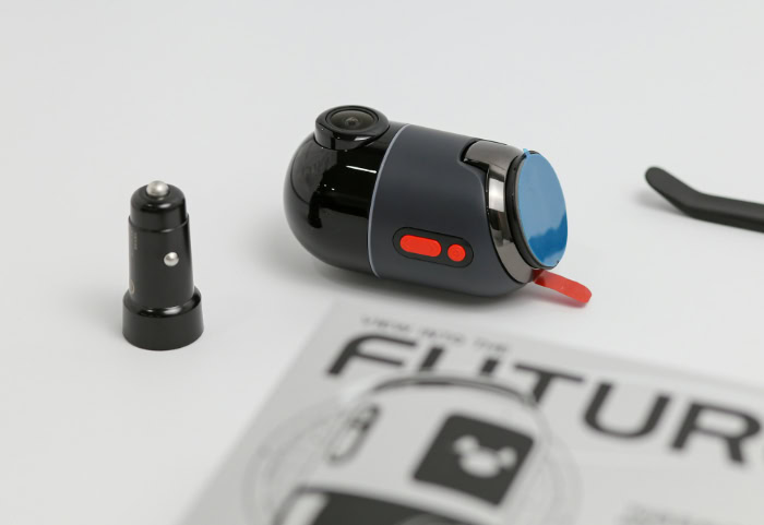 Small grey dashcam with car charger and manual