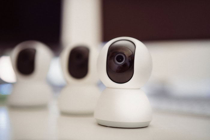 Smart indoor security camera placed on white table
