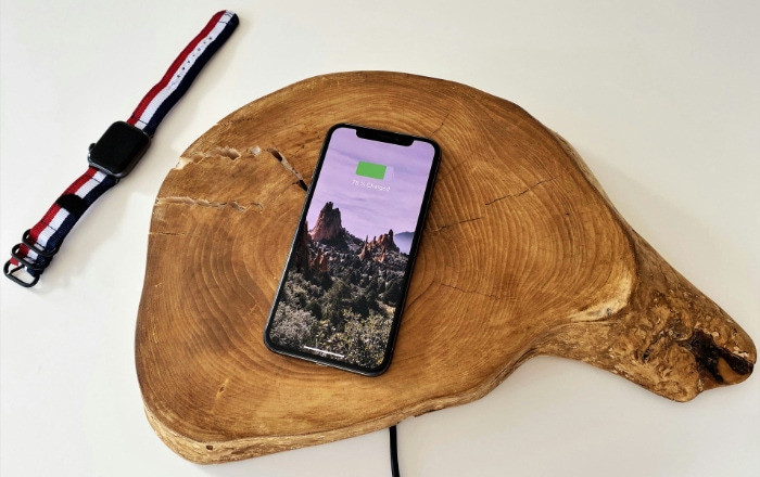 Smartphone charging on a wooden paddle shaped charging station