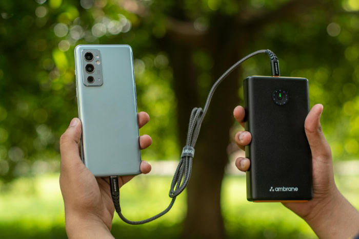 Smartphone connected to a large power bank outdoors