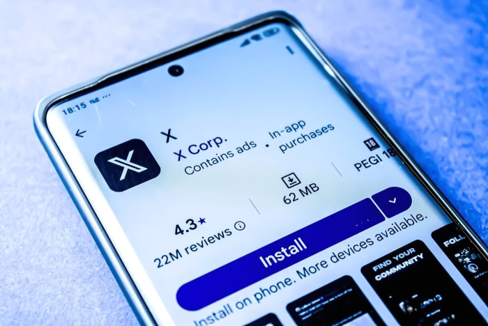 Smartphone showing X app on Google Play Store