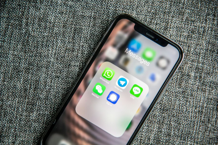 Smartphone showing encrypted messaging apps on screen
