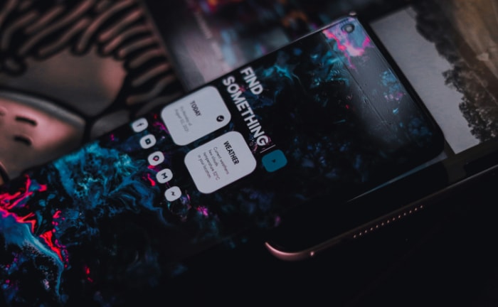 Smartphone with abstract wallpaper and custom widgets