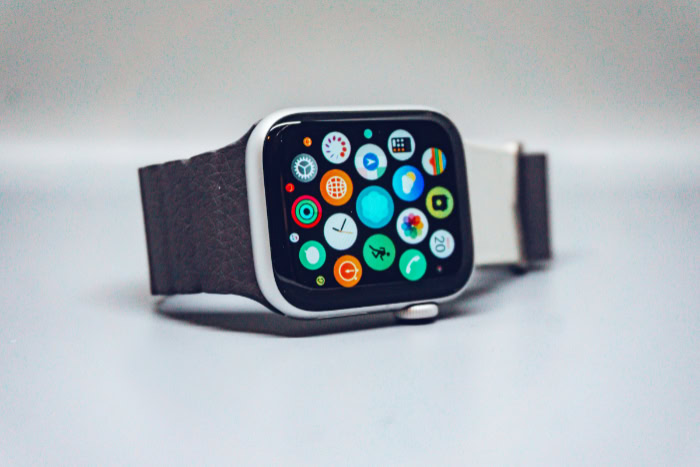 Smartwatch display with colorful app icons and leather strap