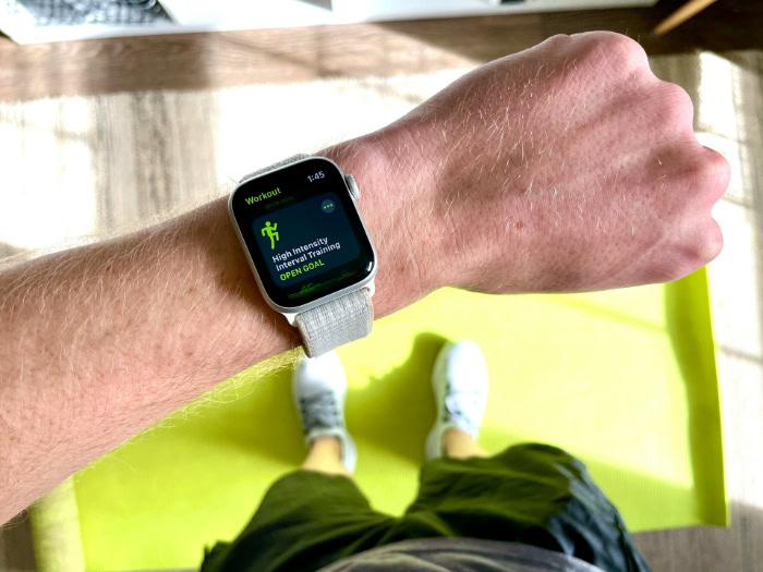 Smartwatch displaying fitness workout app on wrist