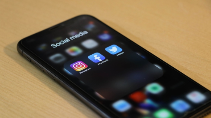 Black smartphone showing social media apps