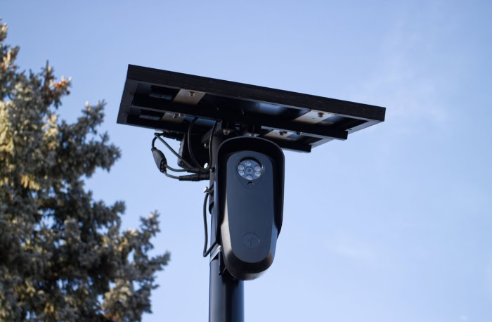Solar powered outdoor security camera mounted on pole