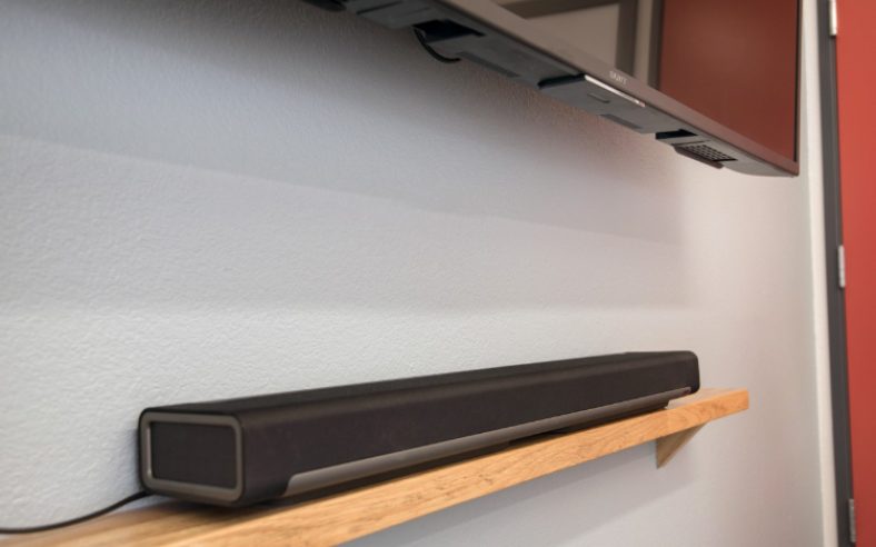 Black Sonos Playbar on wooden rack