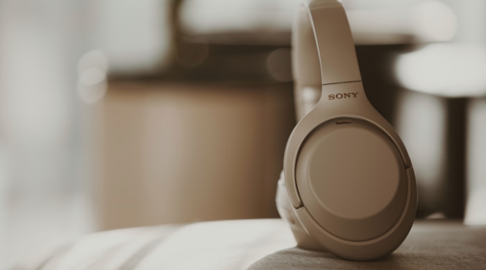 Silver Sony headphones on couch