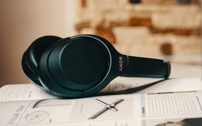 Sony noise cancelling headphones placed on an open magazine