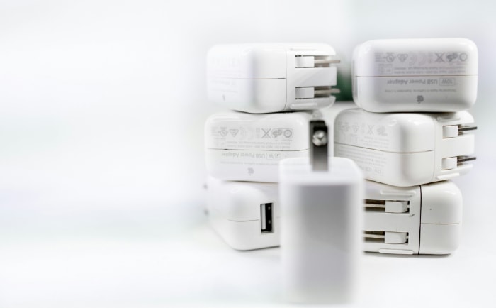 Stack of white USB power adapters with multiple ports 1