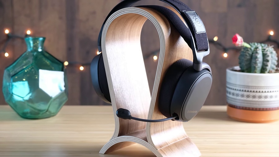 Black SteelSeries Arctis Pro Wireless on wooden headphone stand