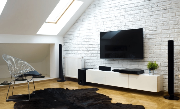 Stylish living room with TV and tall black floor speakers