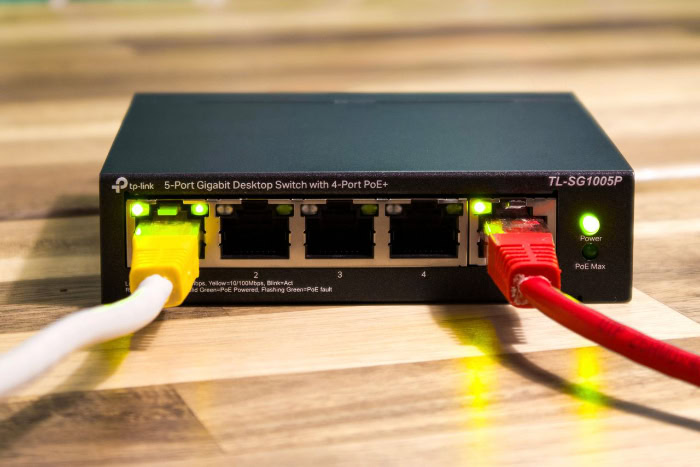 TP Link desktop network switch with connected ethernet cables