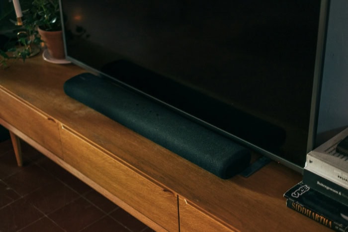 TV and soundbar setup on a wooden cabinet