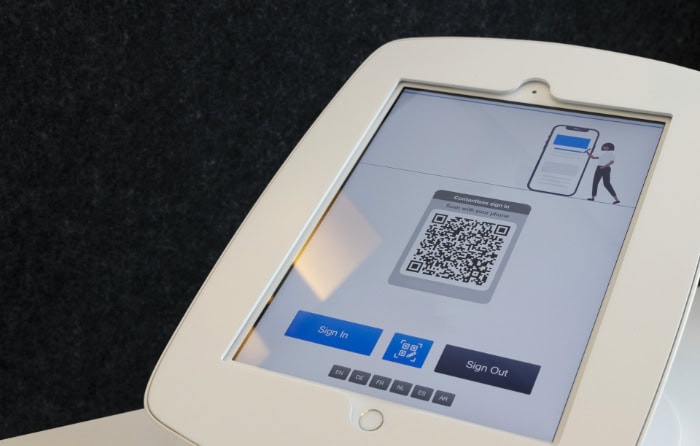 Tablet display showing QR code sign in interface for contactless check in