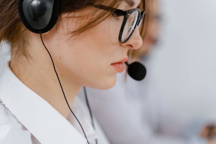 Telemarketer wearing headset in office setting