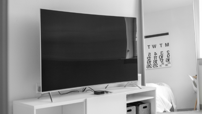 Black TV on white desk