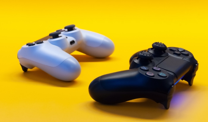 Two PS4 controller on yellow background