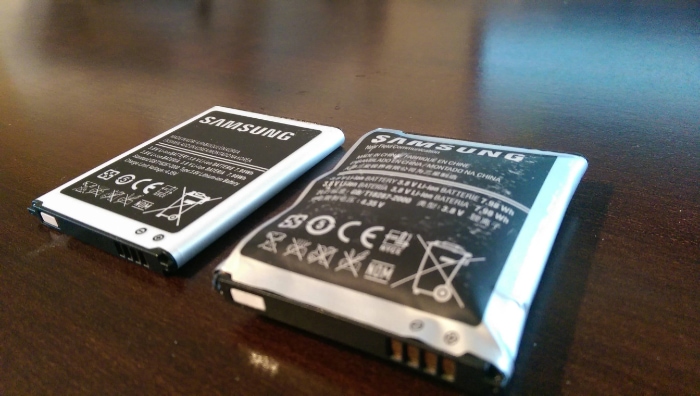 Two smartphone batteries side by side and one visibly swollen