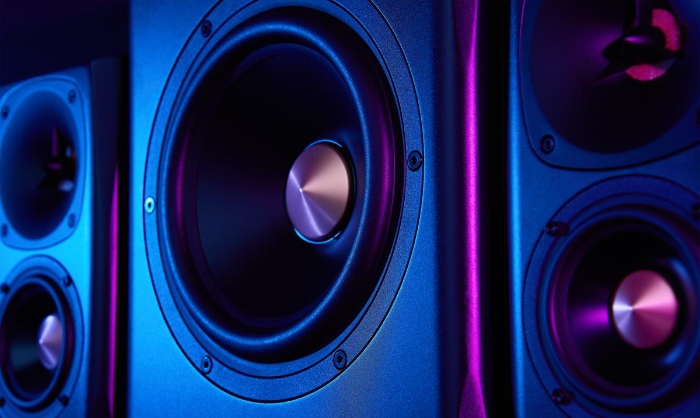 Two sound speakers and subwoofer on dark background