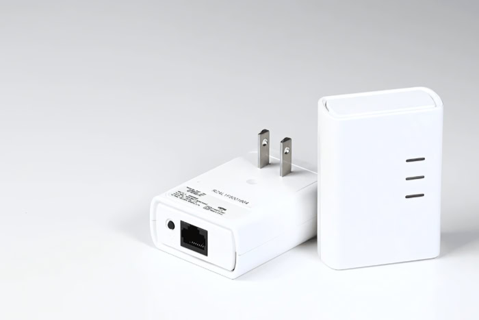 Two white powerline network adapters with ethernet ports