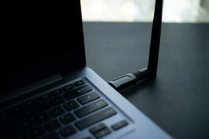 USB Wi Fi adapter plugged into a laptop side port