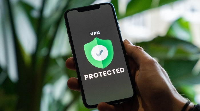 Phone on hand showing VPN protected