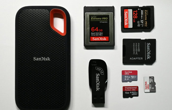 Various SanDisk storage devices on white surface