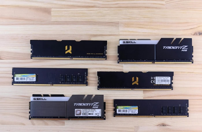 Various computer RAM sticks on wooden surface