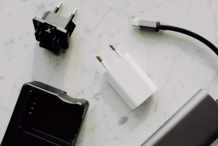 Various power adapters and USB C cable on marble surface