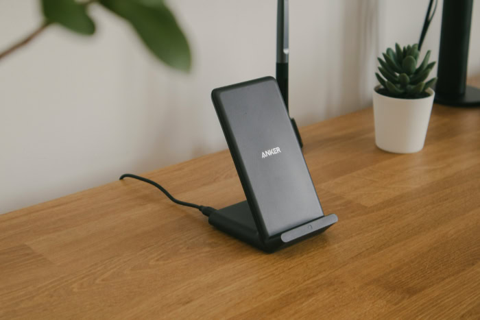 Vertical wireless charging stand on wooden desk