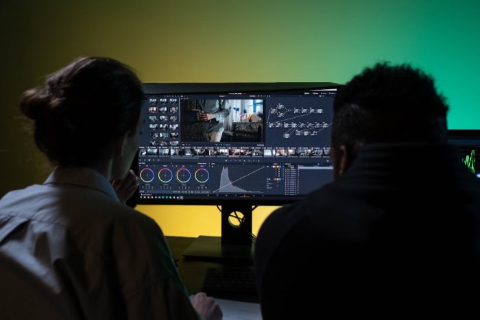 Video editors working on color grading in DaVinci Resolve