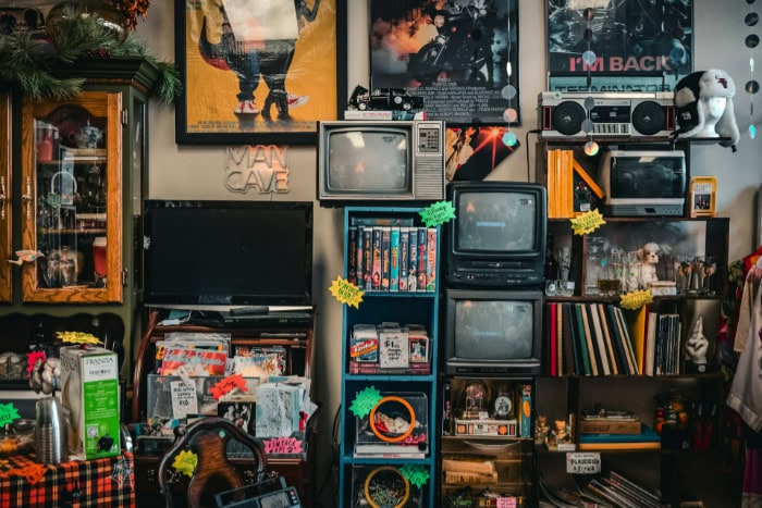 Vintage man cave display with retro TVs and movie posters