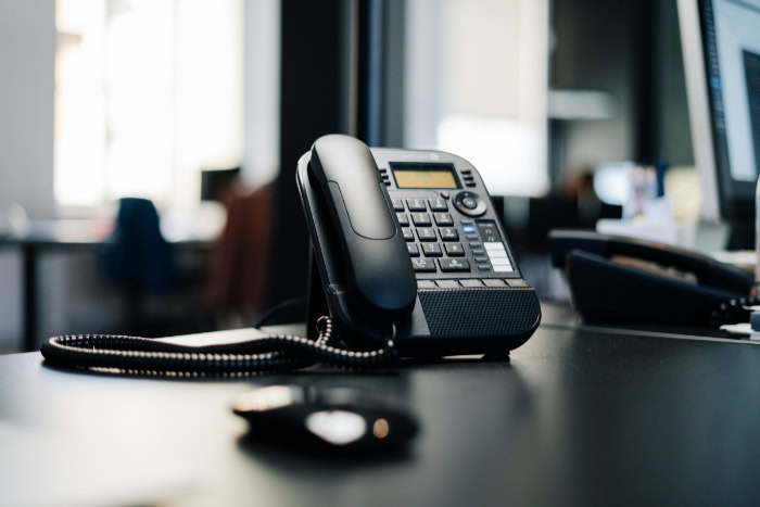 VoIP desk phone placed on a modern office desk