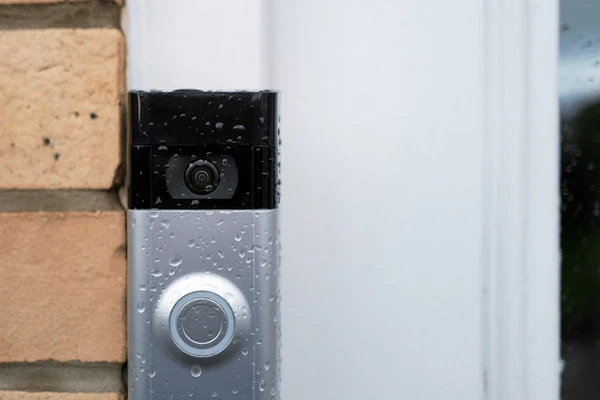 Water droplets covering a smart video doorbell camera