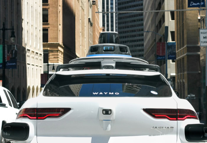 Waymo autonomous self driving Jaguar car on city street