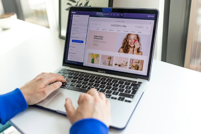 Web designer editing online store on laptop