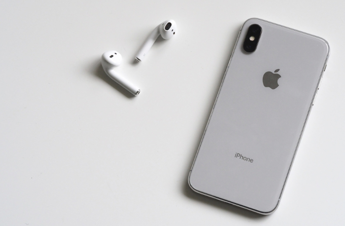 White AirPods beside iPhone