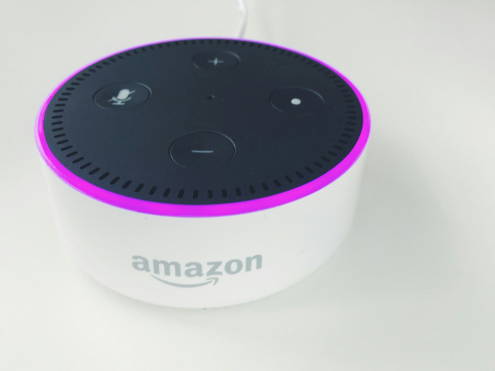 White Amazon Echo Dot with purple LED ring