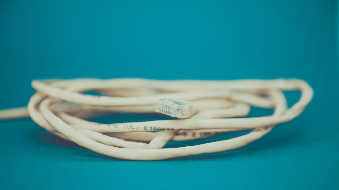White LAN cable close up on blue background