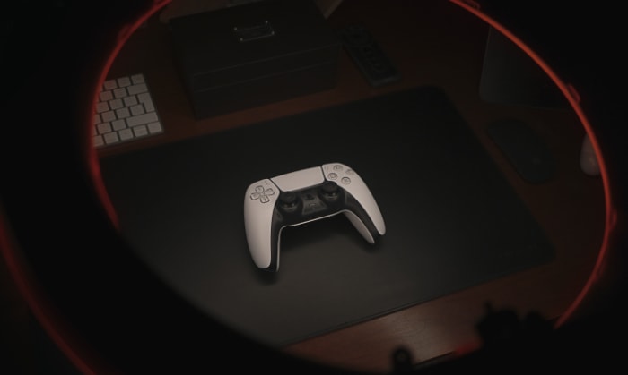 White PS5 controller on a dark desk