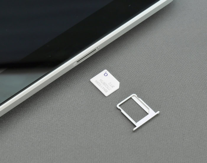 White SIM card with ejected metal SIM tray
