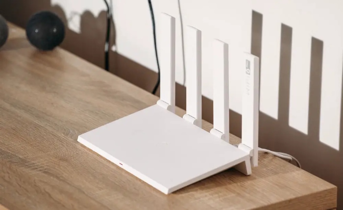 White Wi Fi 6 router with 4 antennas on a table