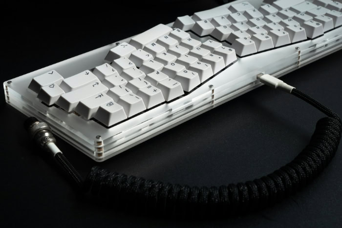 White ergonomic mechanical keyboard with black coiled cable