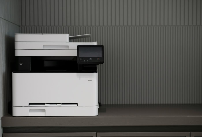 White multifunction printer with digital display on shelf