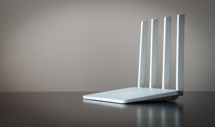 White tri-band router on a dark surface