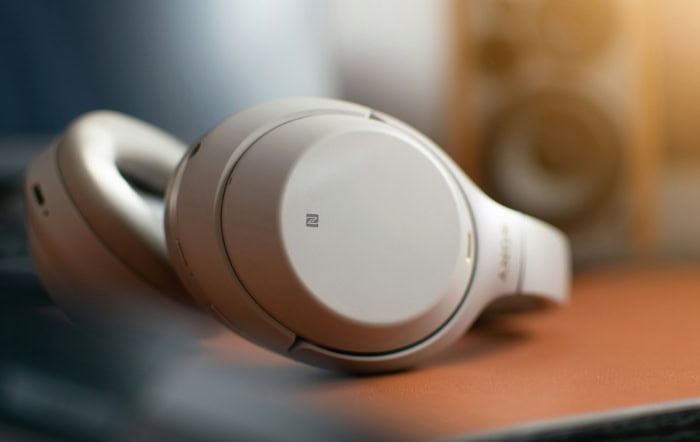 White sony wireless headphones on blurred background