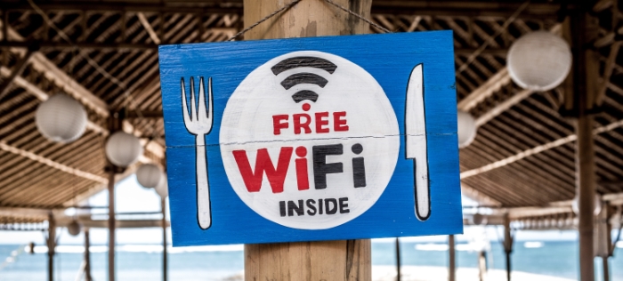 Free WiFi sign on wooden post