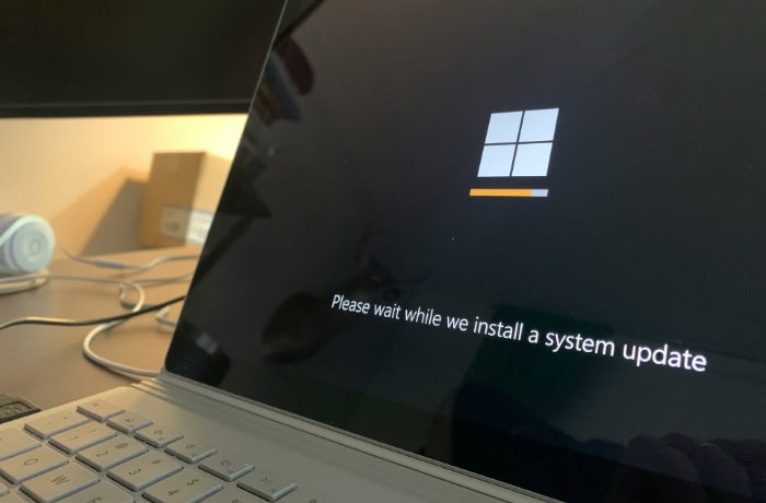 Windows laptop displaying Installing system update screen